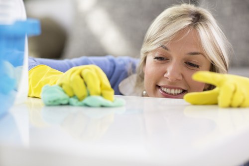 Technician inspecting cleaning products and work area hazards